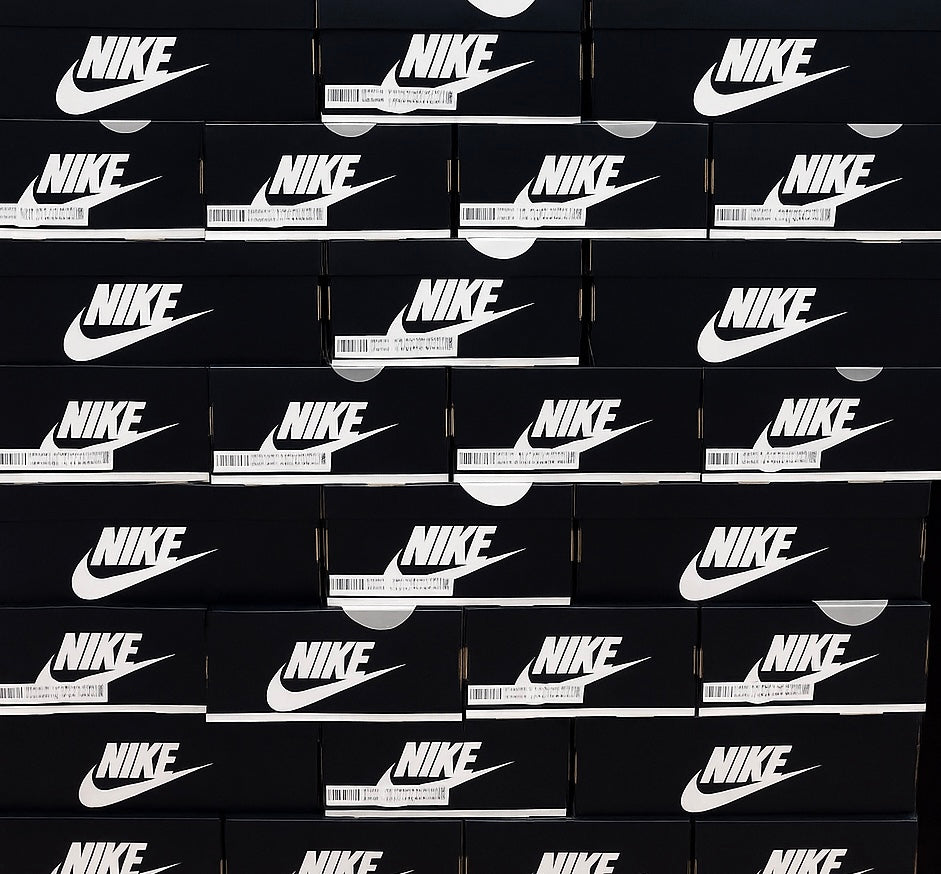 Stack of black Nike boxes with white logos