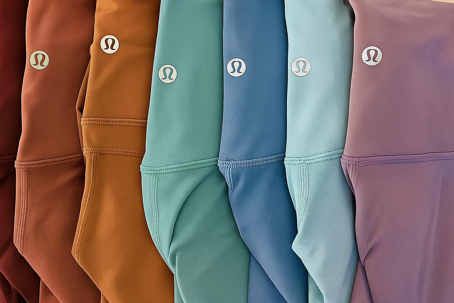 Row of colorful shorts with a brand logo on each, displayed in a gradient from brown to purple.