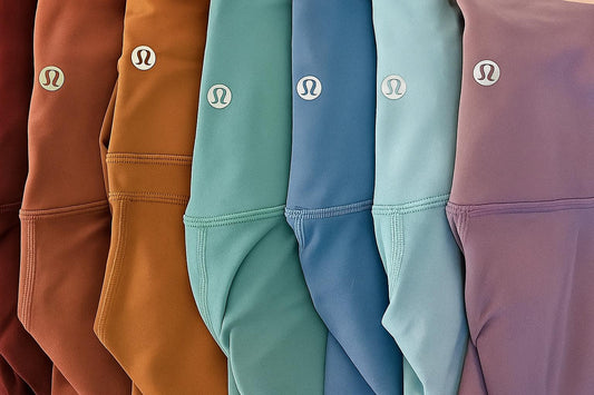 Row of colorful shorts with a brand logo on each, displayed in a gradient from brown to purple.