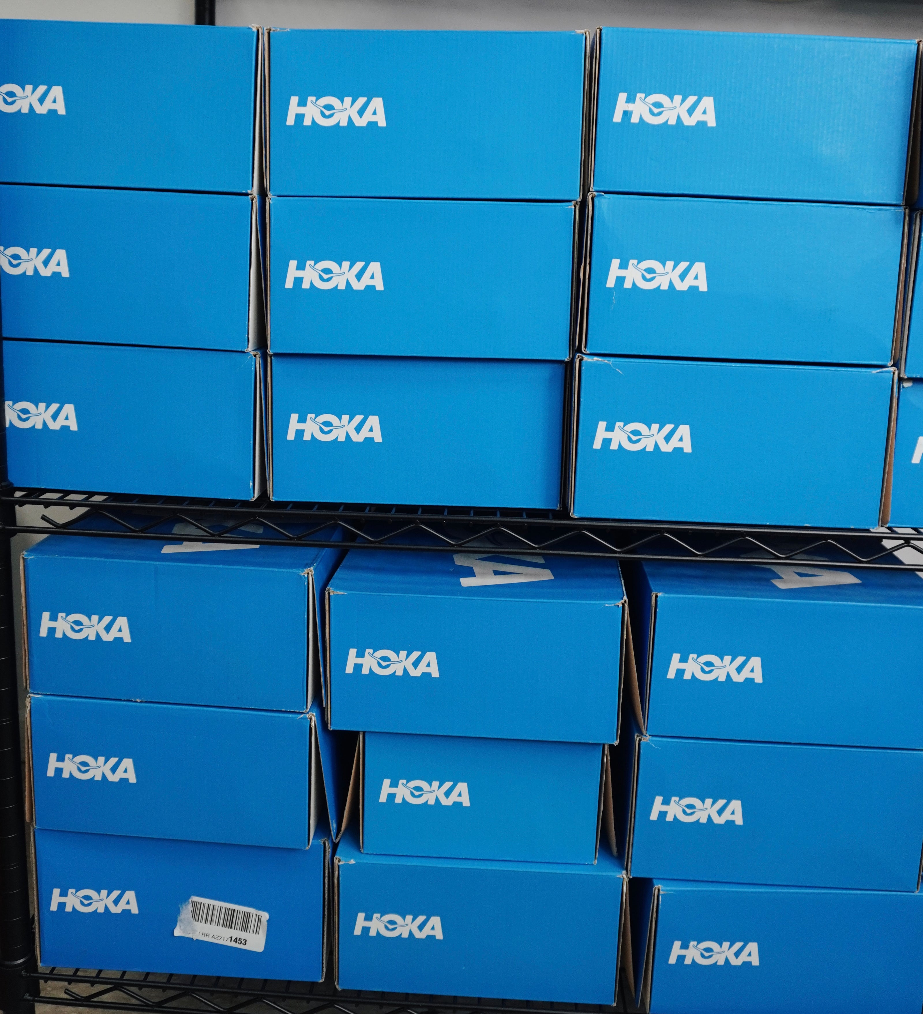 A stack of hoka boxes on a metal rack